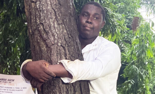 Ghanaian journalist hugs tree for 24 hours to break record and promote reforestation