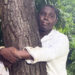 Ghanaian journalist hugs tree for 24 hours to break record and promote reforestation
