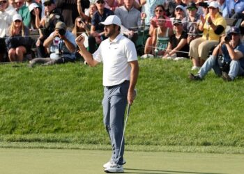 Scottie Scheffler retains Memorial crown despite Shane Lowry's late struggles.